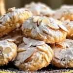 A plate of soft and chewy Italian Almond Cookies (Ricciarelli), dusted with powdered sugar and arranged beautifully for serving.