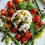 A colorful Asparagus Tomato Salad with Burrata Cheese, drizzled with balsamic glaze and garnished with fresh basil.