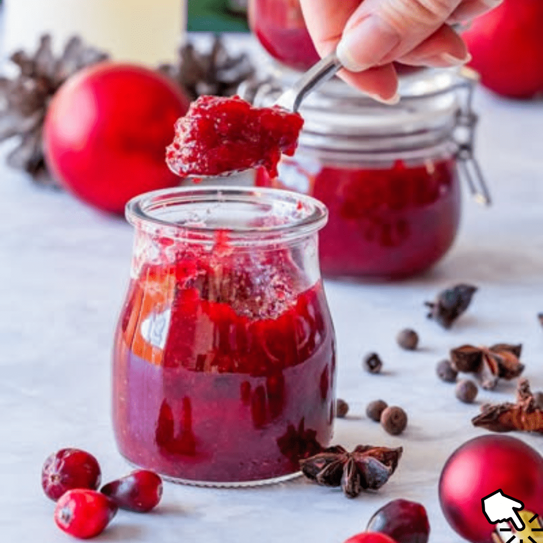 Festive Christmas freezer jam in jars, surrounded by fresh fruits and holiday decorations.