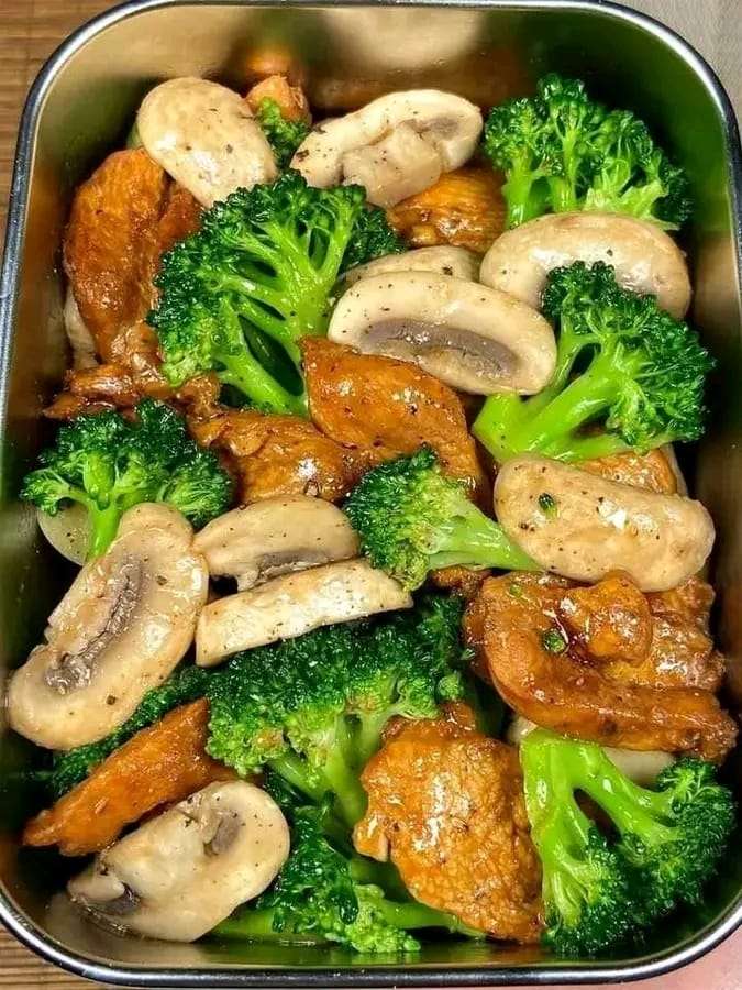 Shiitake Chicken Stir-Fry with tender chicken strips, shiitake mushrooms, broccoli, and garnished with green onions on a plate.