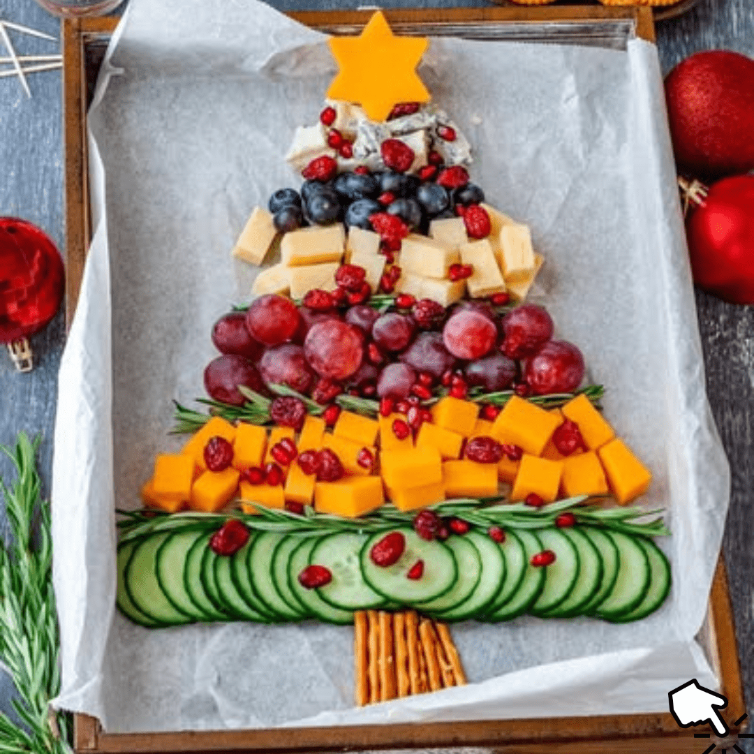 A festive Christmas tree-shaped cheese board with fruits, nuts, and crackers arranged for holiday entertaining.