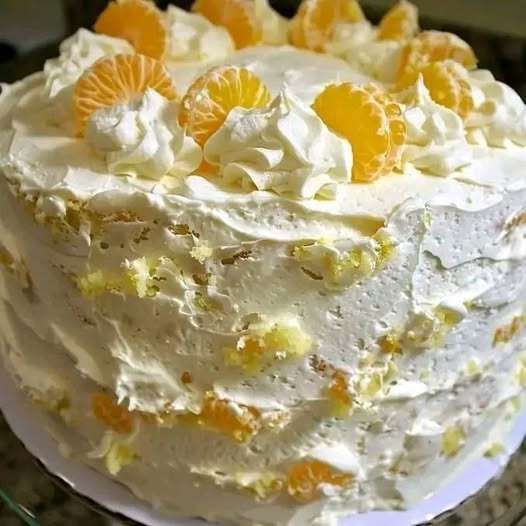 A moist and refreshing Mandarin Orange Pineapple Cake topped with creamy Cool Whip icing, with hints of mandarin oranges and pineapple.