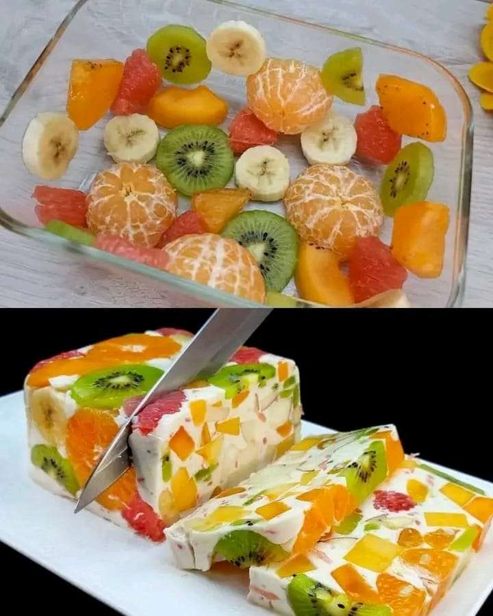 A vibrant Milk Fruit Jelly Dessert with layers of fresh tangerines, kiwis, and creamy milk, served in a glass dish.