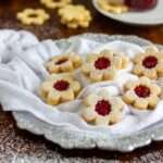 Festive Linzer Cookies with Raspberry Jam and Powdered Sugar