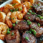 Juicy steak bites and shrimp coated in a glossy butter soy glaze served over rice.