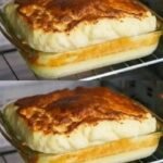 A glass baking dish inside an oven featuring a savory base topped with a massive, golden-brown, and airy soufflé-style egg-white crust.